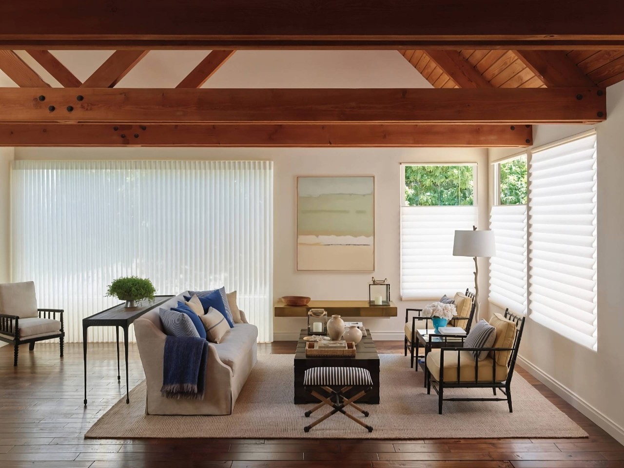 Hunter Douglas Vignette® Roman Shades in a neutral, modern living room with high beam ceilings at Window Decor of Fairfax near Fairfax, VA